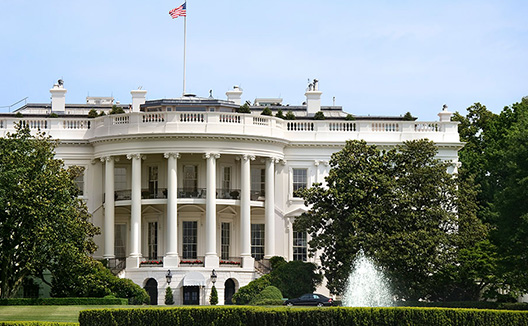 the white house with fountain in the foreground
